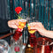 Hands toasting with sparkling beverages in the tipsy turvy bar glasses