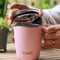 model using light pink stainless steel mug with lid