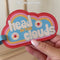 model using cloud shaped 'head in the clouds' luggage tag
