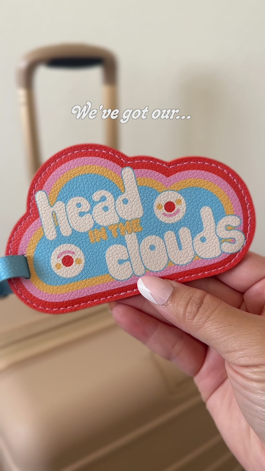 model using cloud shaped 'head in the clouds' luggage tag