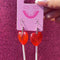 model showcasing red heart lollipop earrings