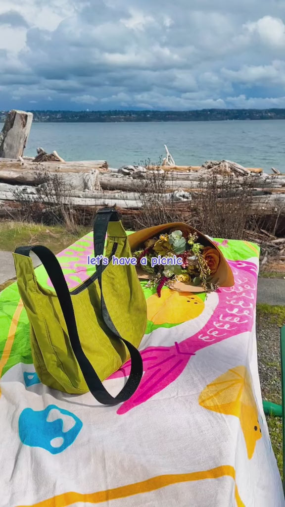 model having a picnic with their dog and sardine towel