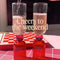 model pouring a beverage in pink bar glass set