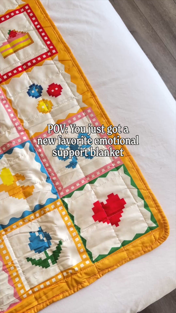 model laying out quilted blanket