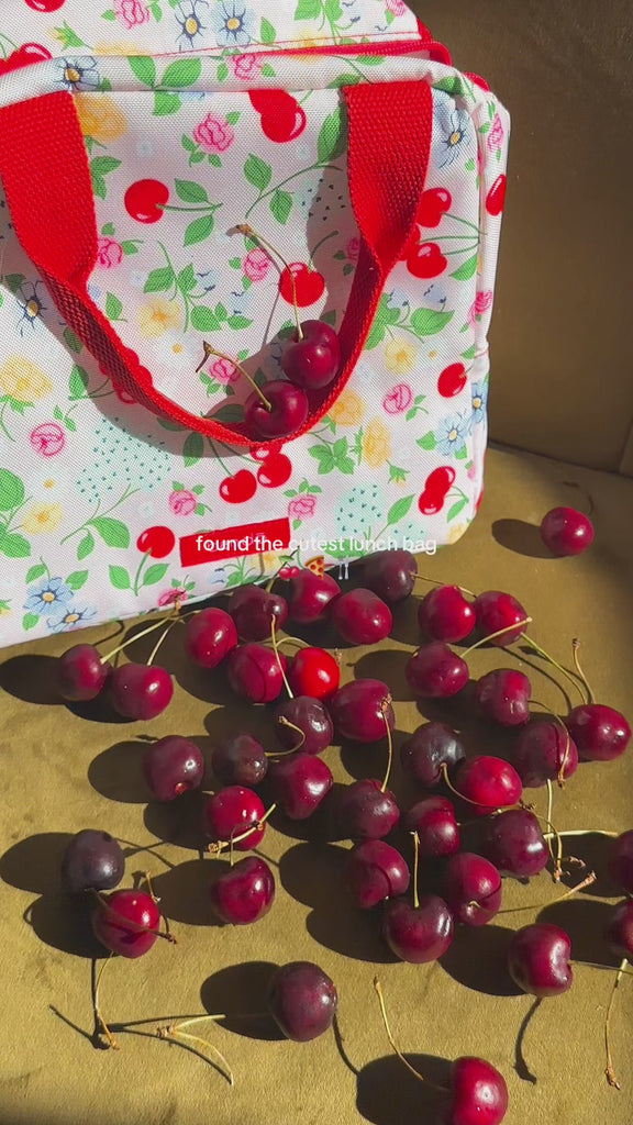 showcasing light pink lunch bag with floral and cherry print