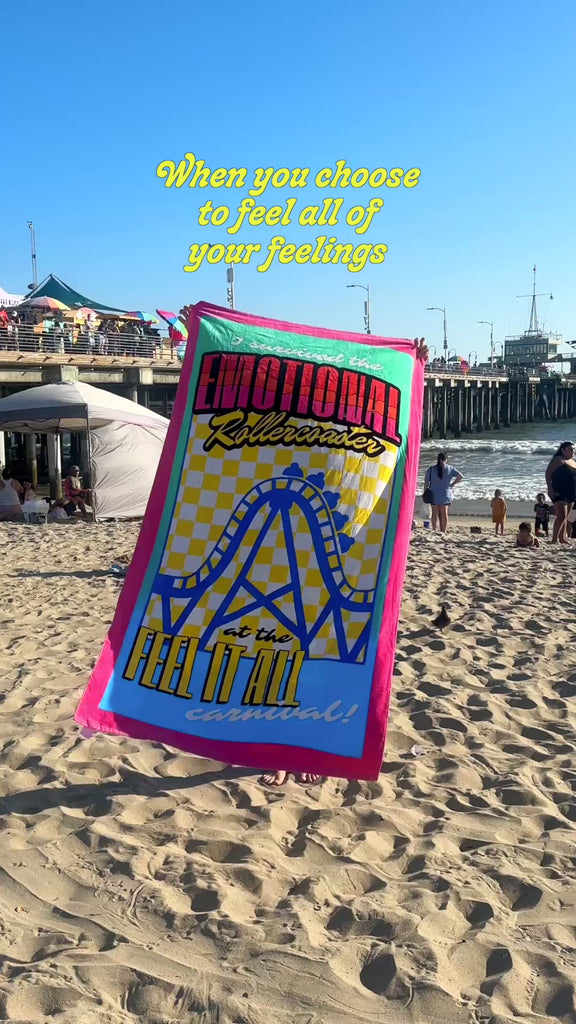 model unfolding emotional rollercoaster towel on the beach