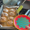 model putting cinnamon bun on colorful dessert plates