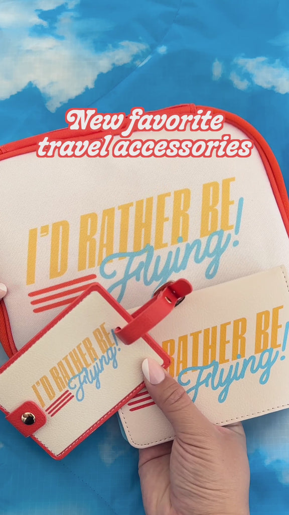 model showcasing 'i'd rather be flying luggage tag, mobile case, and passport holder