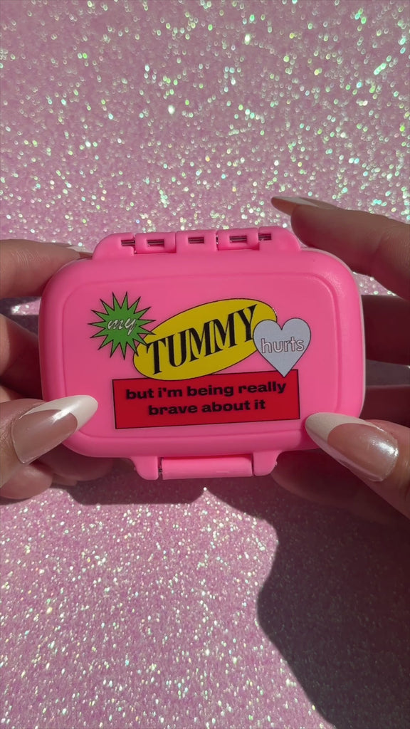 model showcasing interior of my tummy hurts pill case