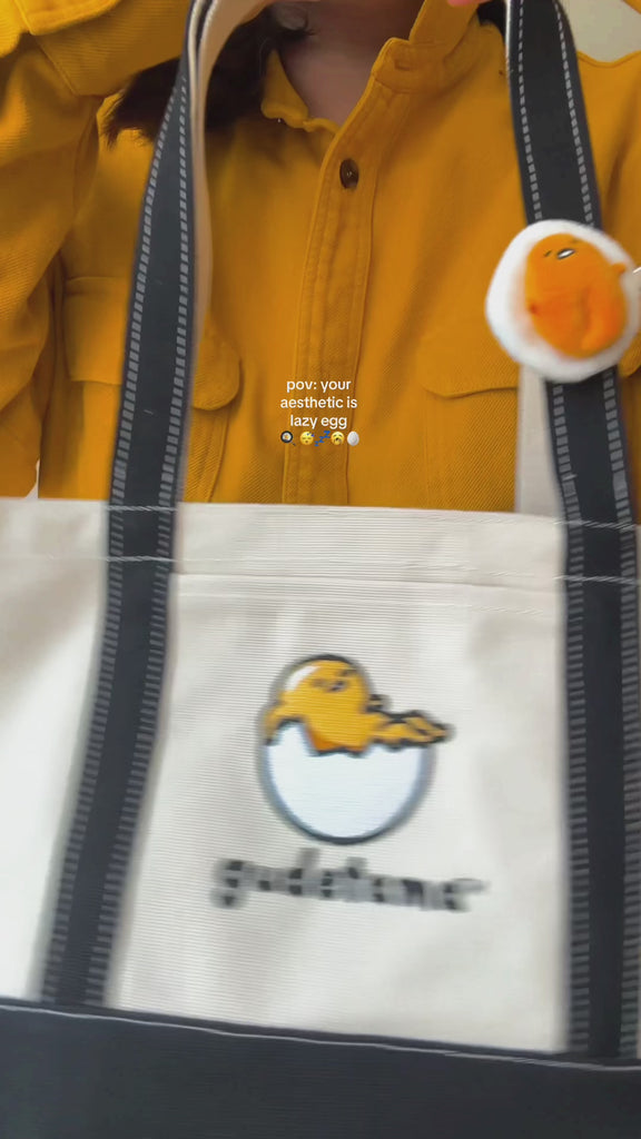 model putting items inside of baggu gudetama bag