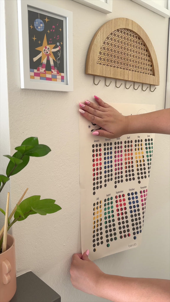 model hanging colorful lunar phases poster on their wall