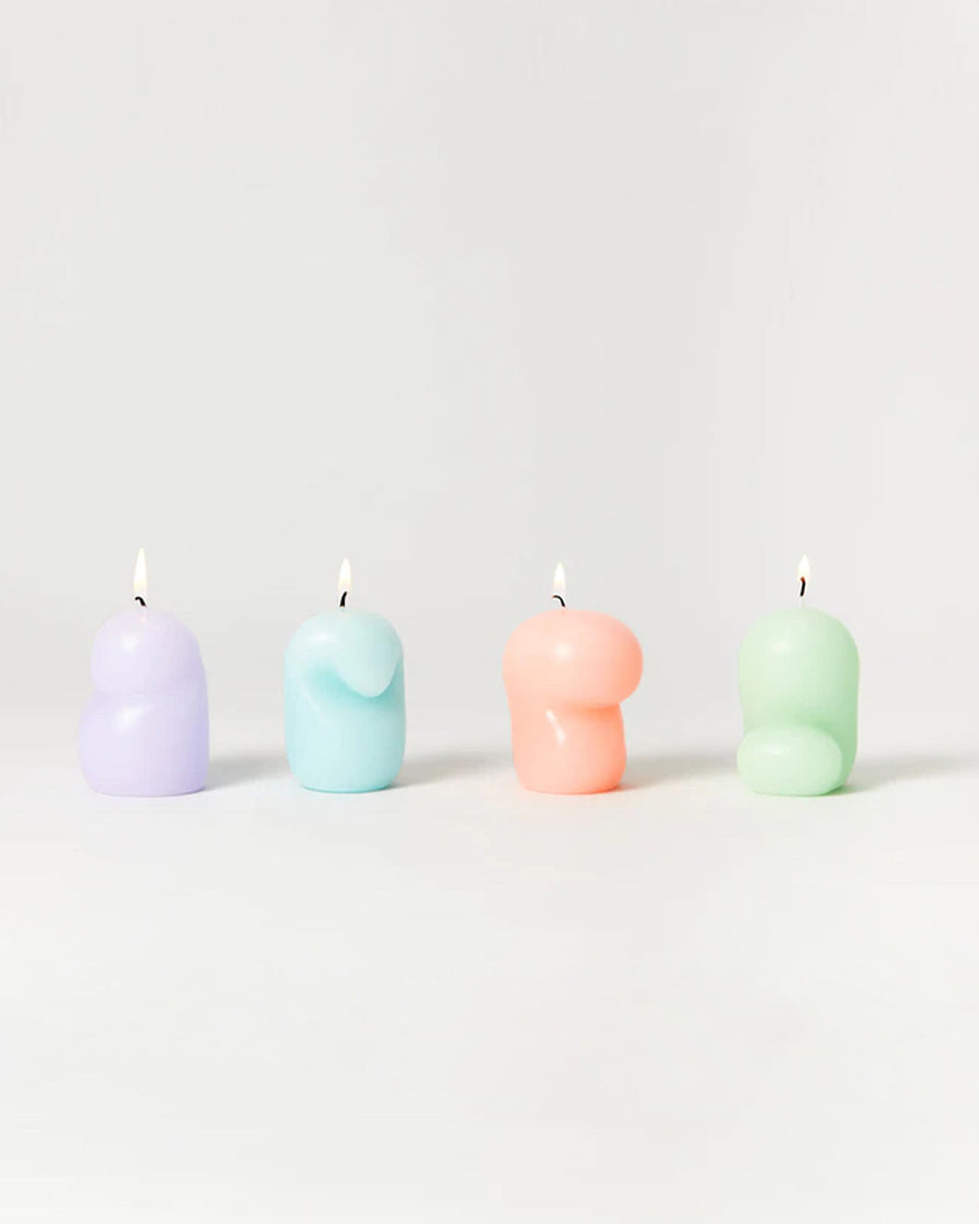 set of four goober mini candles in purple, blue, coral and green lit