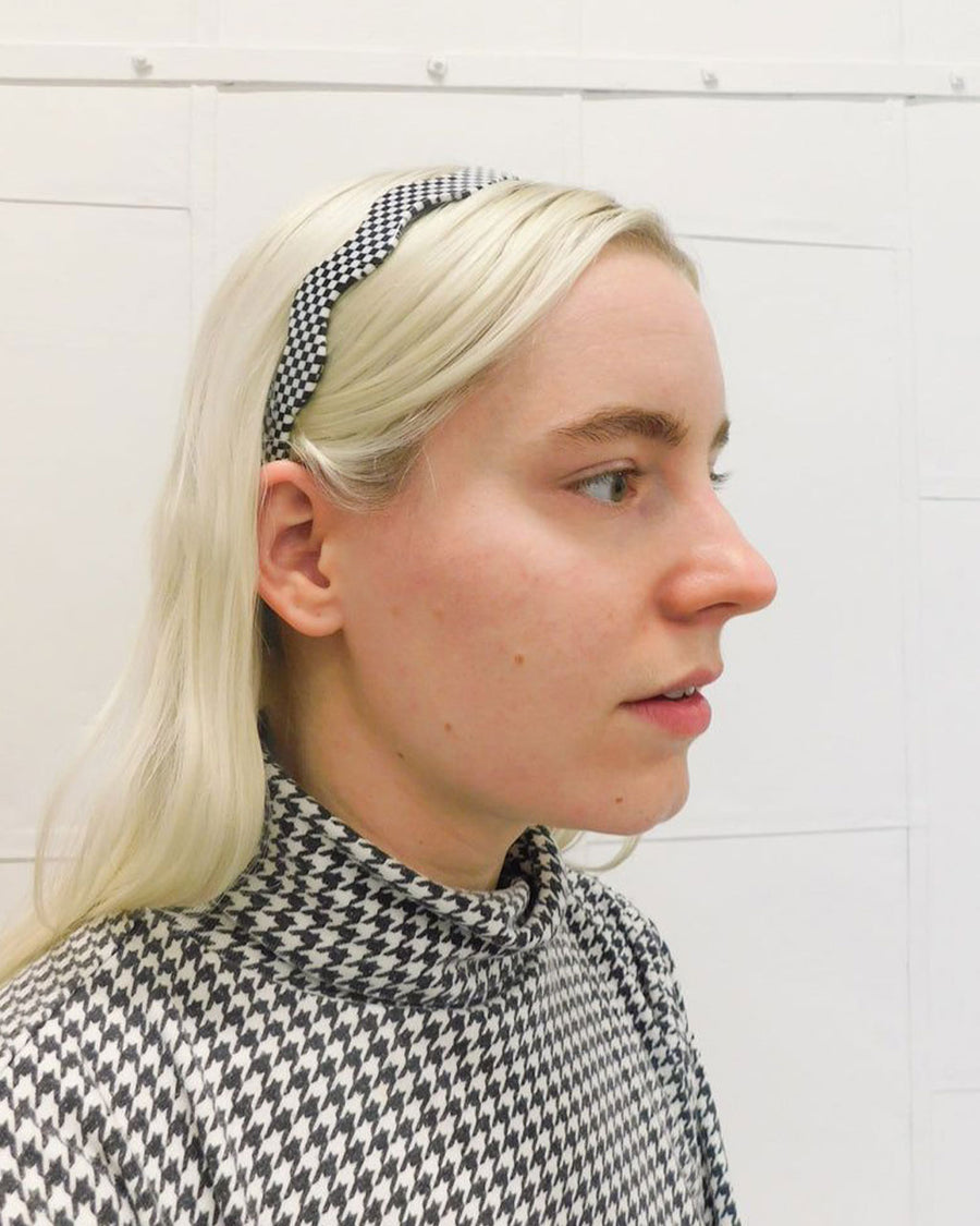 model wearing wavy black and white checkered headband