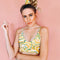 model wearing yellow swim suit with green and pink swirl floral print