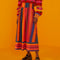 model wearing multicolor vertical and horizontal stripe midi skirt with stripe cherry sweater and black platform shoes