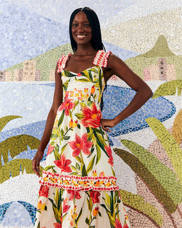 model wearing white midi dress with large all over red flower print, ruffle tank straps, tiered ruffle skirt and cinched bodice