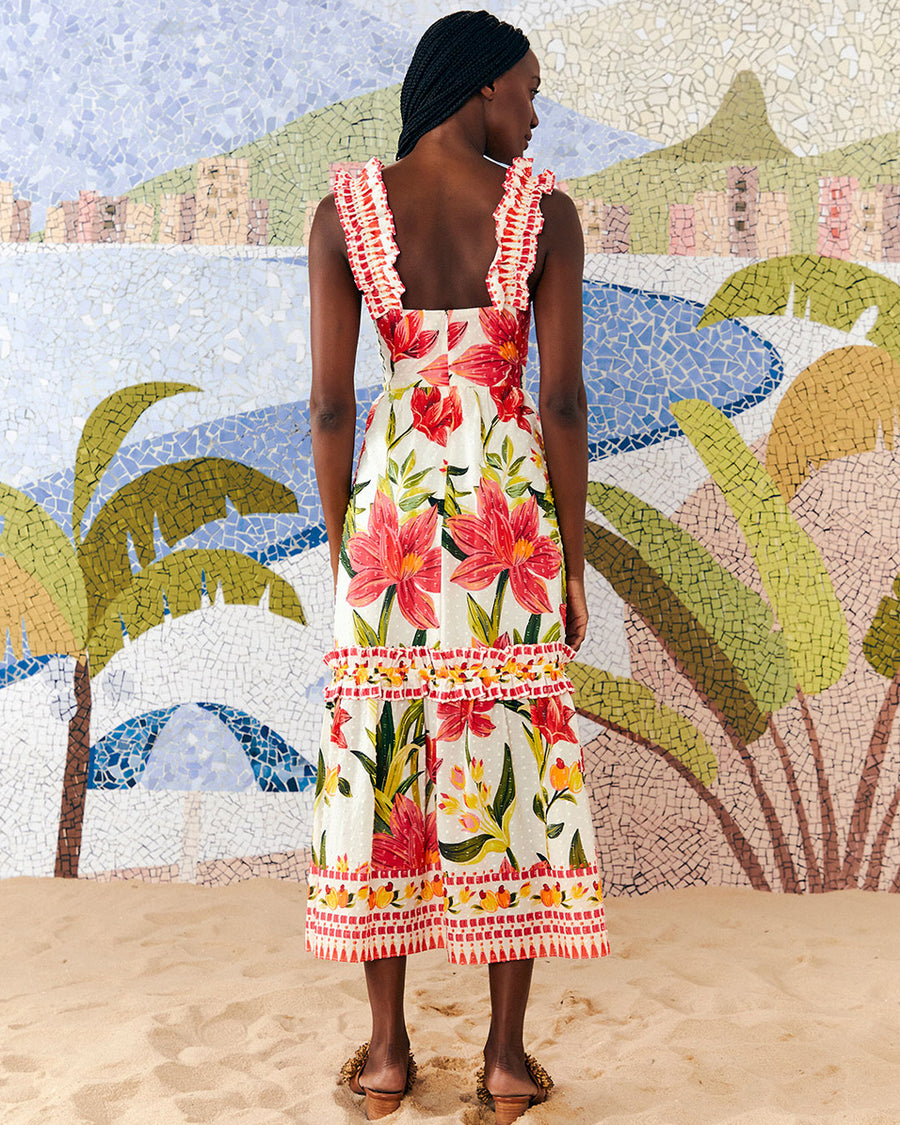 backview of model wearing white midi dress with large all over red flower print, ruffle tank straps, tiered ruffle skirt and cinched bodice