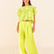 model wearing lime green linen pants with wide legs