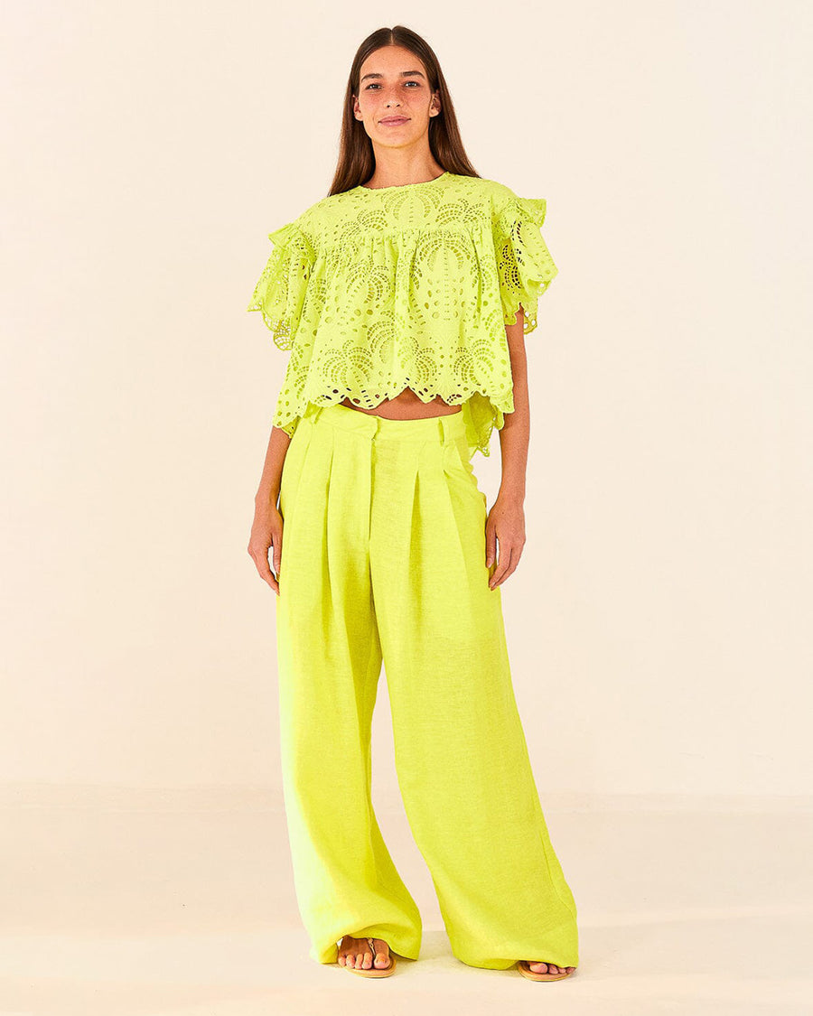 model wearing lime green linen pants with wide legs