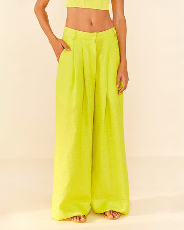 model wearing lime green linen pants with wide legs