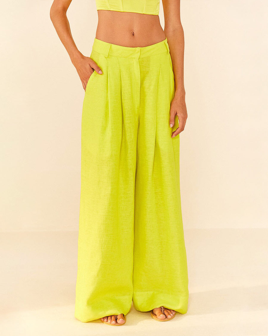 model wearing lime green linen pants with wide legs