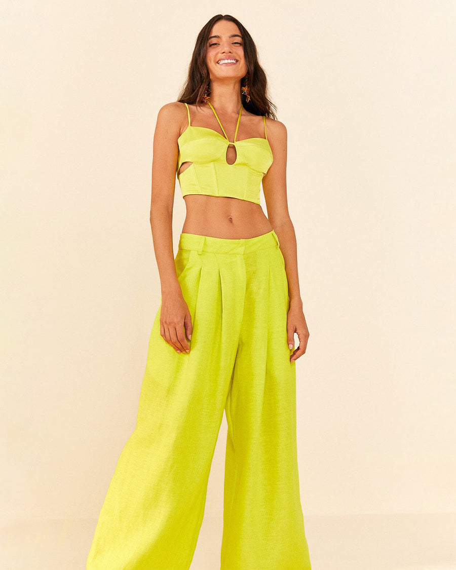 model wearing model wearing lime green linen pants with wide legs and matching top