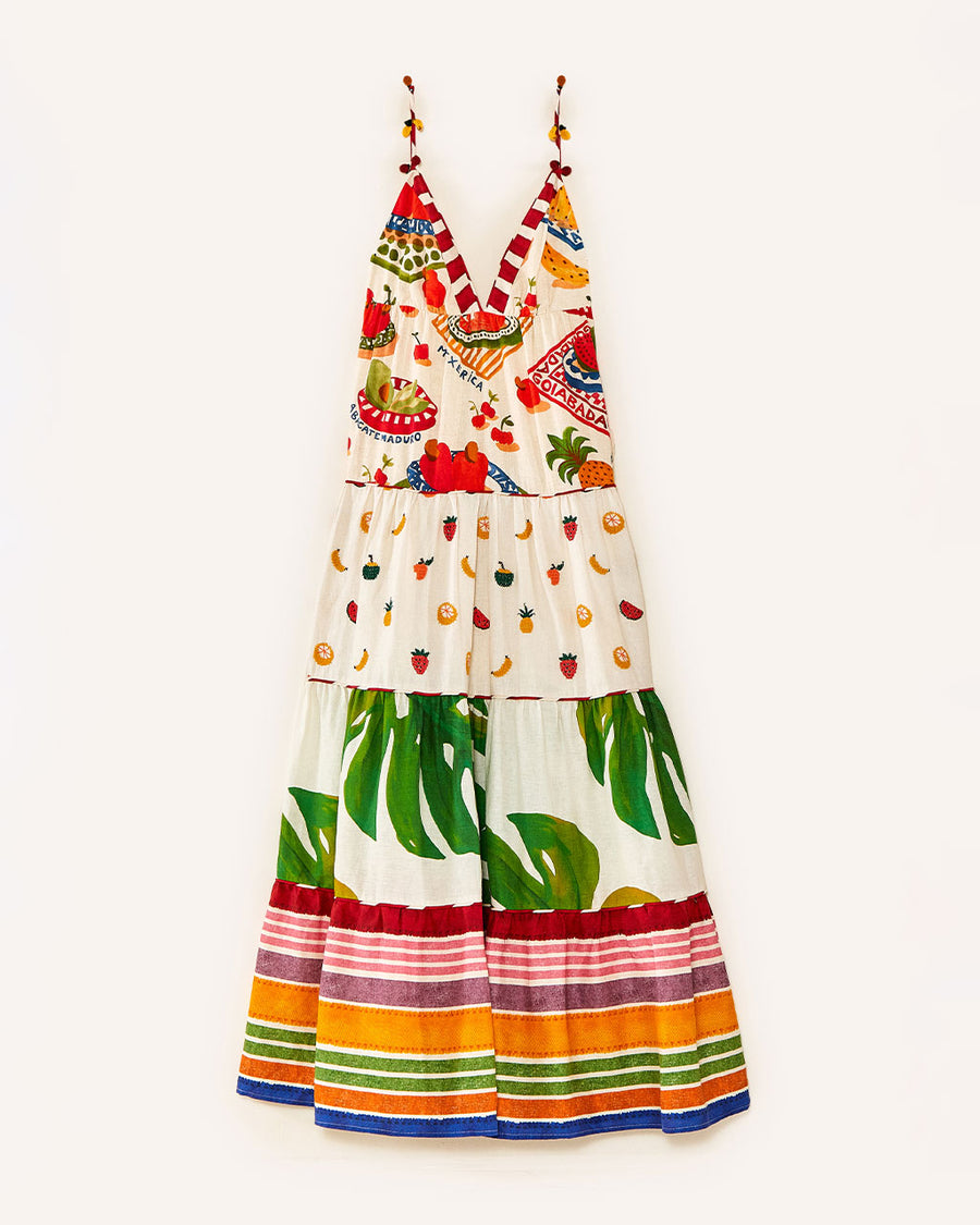 still image of  white maxi dress with various different multicolor prints, fruit charms on straps and deep v neckline