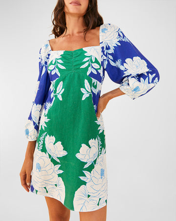 model wearing blue and green linen mini dress with all over white floral print, square neckline and slight blouson sleeves