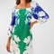 model wearing blue and green linen mini dress with all over white floral print, square neckline and slight blouson sleeves