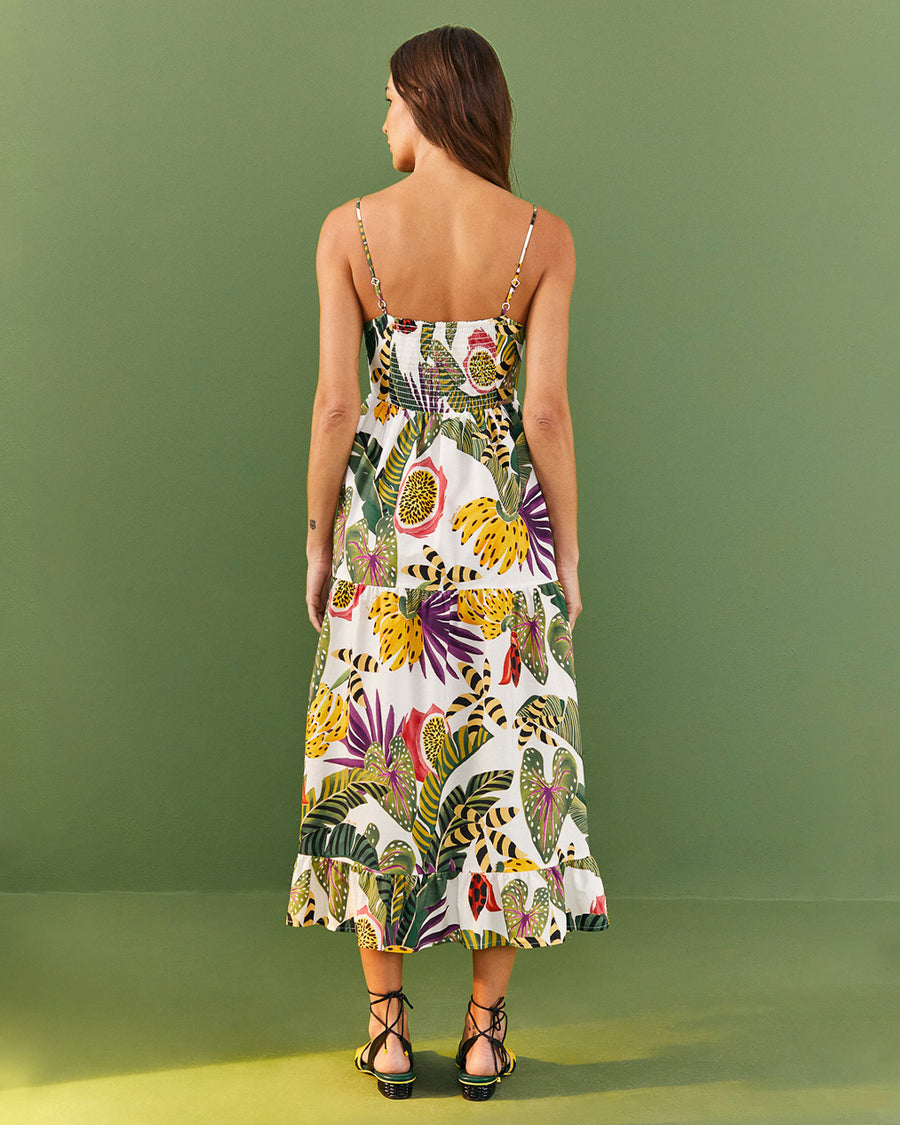 backview of model wearing white midi sundress with vibrant forest leaf print and back smocking