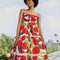 model wearing large tomato print midi dress with lace inset tiers and beaded neck ties