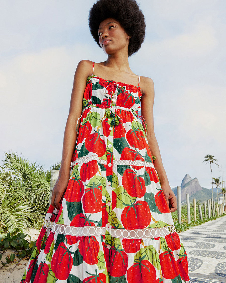 model wearing large tomato print midi dress with lace inset tiers and beaded neck ties