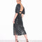 model wearing black sequin midi dress with sequins, open back and puff sleeves