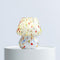 lit white mini mushroom lamp with multicolor streaks