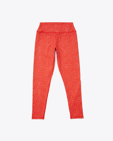 red leggings with a splattered dot design 