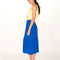 side view of model wearing royal blue button down ruffle midi skirt