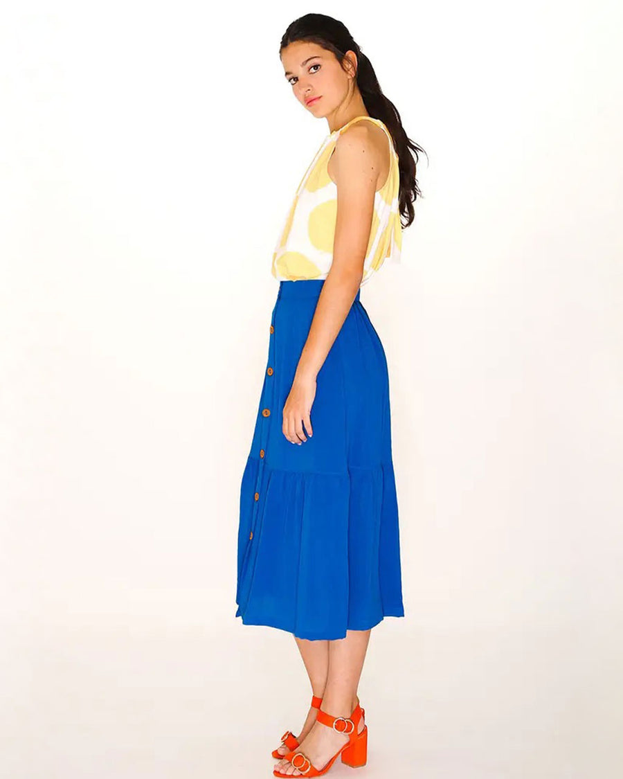 side view of model wearing royal blue button down ruffle midi skirt