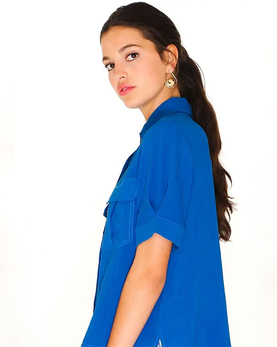 side view of model wearing royal pocket front button down top