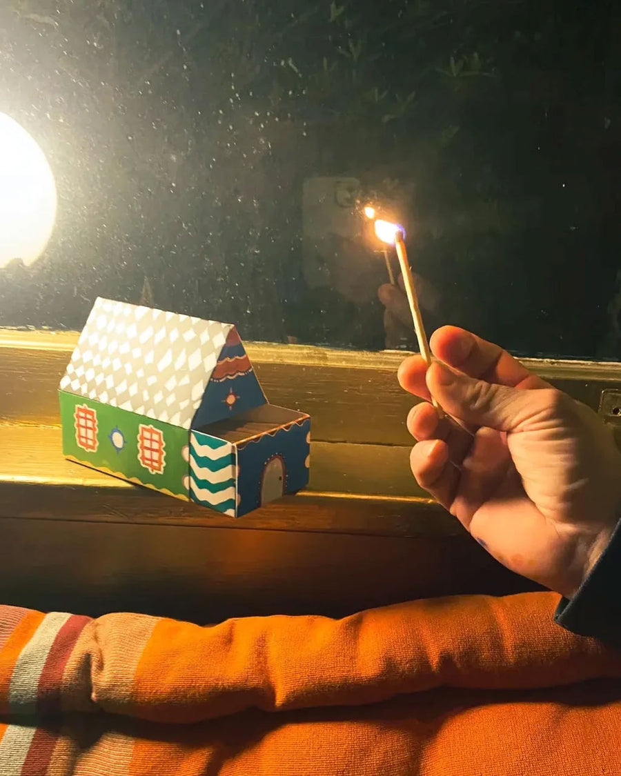 editorial image of matches in a colorful house shaped box