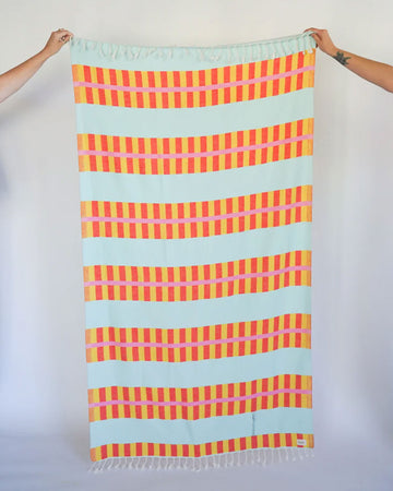 light blue turkish towel with yellow and orange lattice print