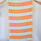 light blue turkish towel with yellow and orange lattice print