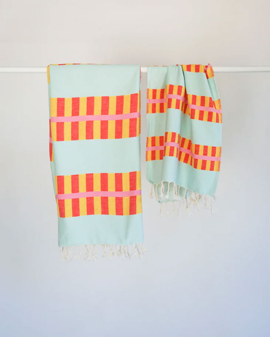 light blue turkish towel with yellow and orange lattice print and matching hand towel