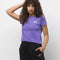 model wearing purple tee with 'vans' graphic on left corner and black sweatpants