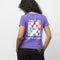 back-view of model wearing purple tee with 'take it one step at a time' vans graphic on back and black sweatpants