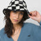 model wearing black and white checker sherpa bucket hat