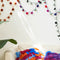 styled room with all three color ways of pom garland and colorful throw pillows