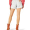 backview of model wearing light blue denim cutoff shorts, cowboy boots and pink sweatshirt