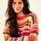 model wearing model wearing yellow, orange, green, pink and red crochet stripe sweater