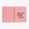 centerfold page of spiral bound notebook with solid pink pages and "YOU ARE EVERYTHING GOOD" text graphic