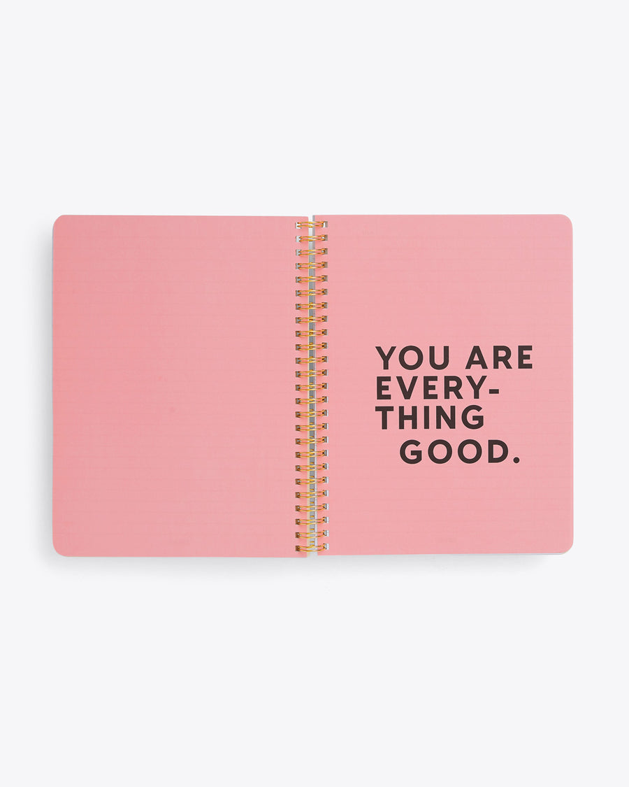 centerfold page of spiral bound notebook with solid pink pages and "YOU ARE EVERYTHING GOOD" text graphic